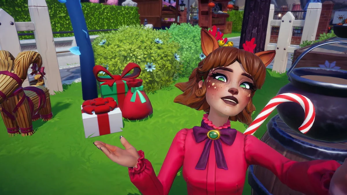 A player dressed as a reindeer with ears, antlers, and a nose holding out their hand under a pile of three presents while smiling in Disney Dreamlight Valley.