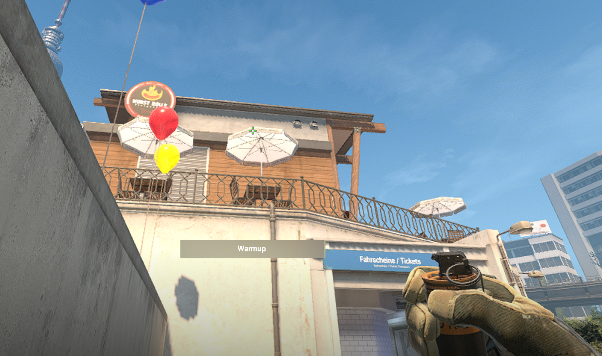 A CS2 character holding a smoke up towards Bank in Overpass.