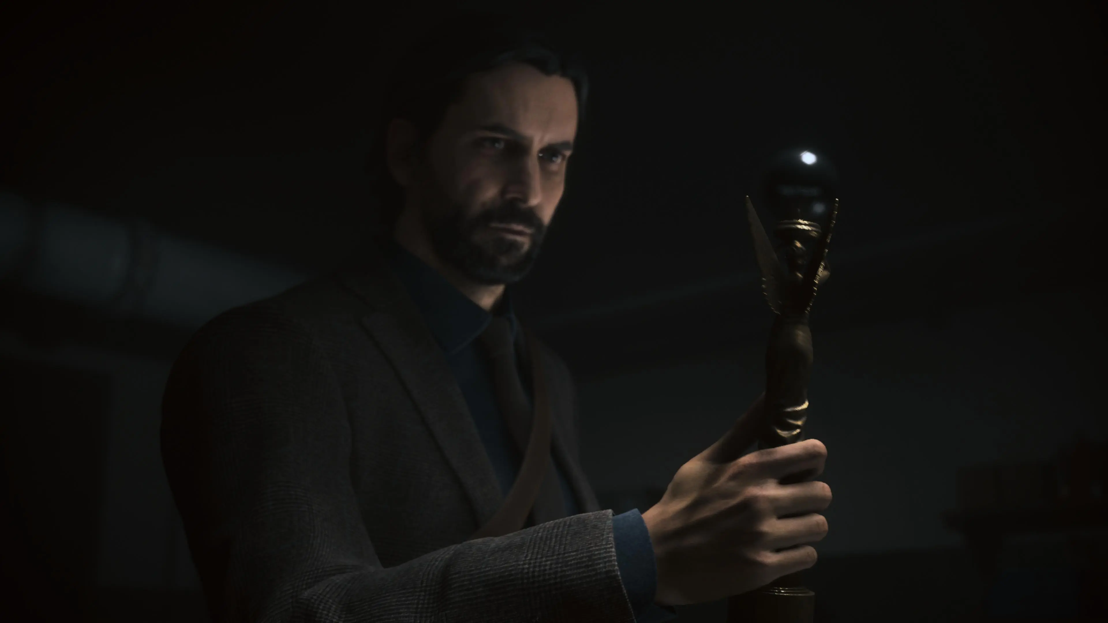 Alan Wake holds the angel lamp