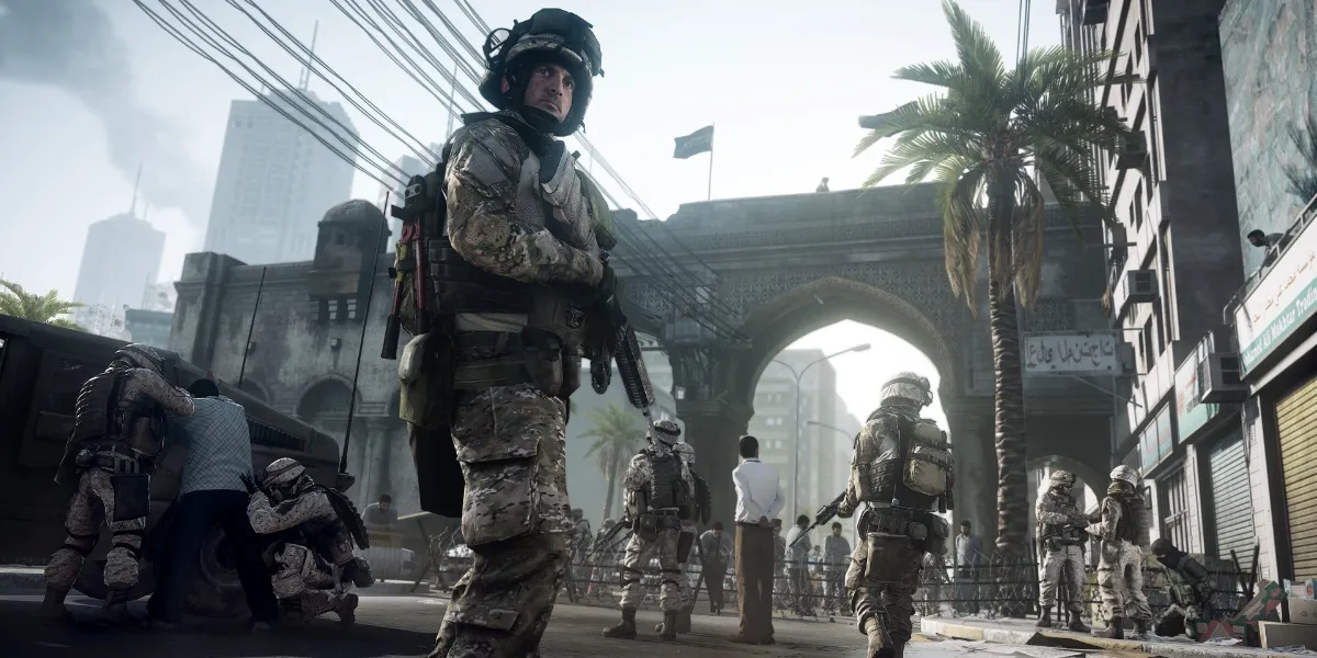 Soldiers walking under a large bridge-like structure with one soldier looking back over their shoulder