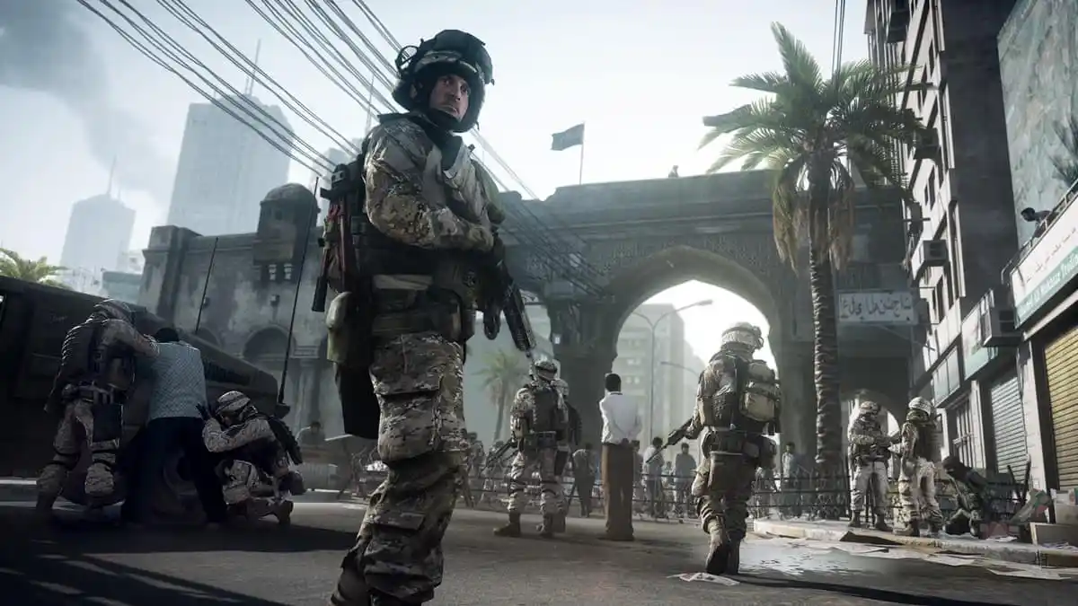 Soldier holding a gun patrolling the streets of a crowded city with other soldiers in Battlefield 3