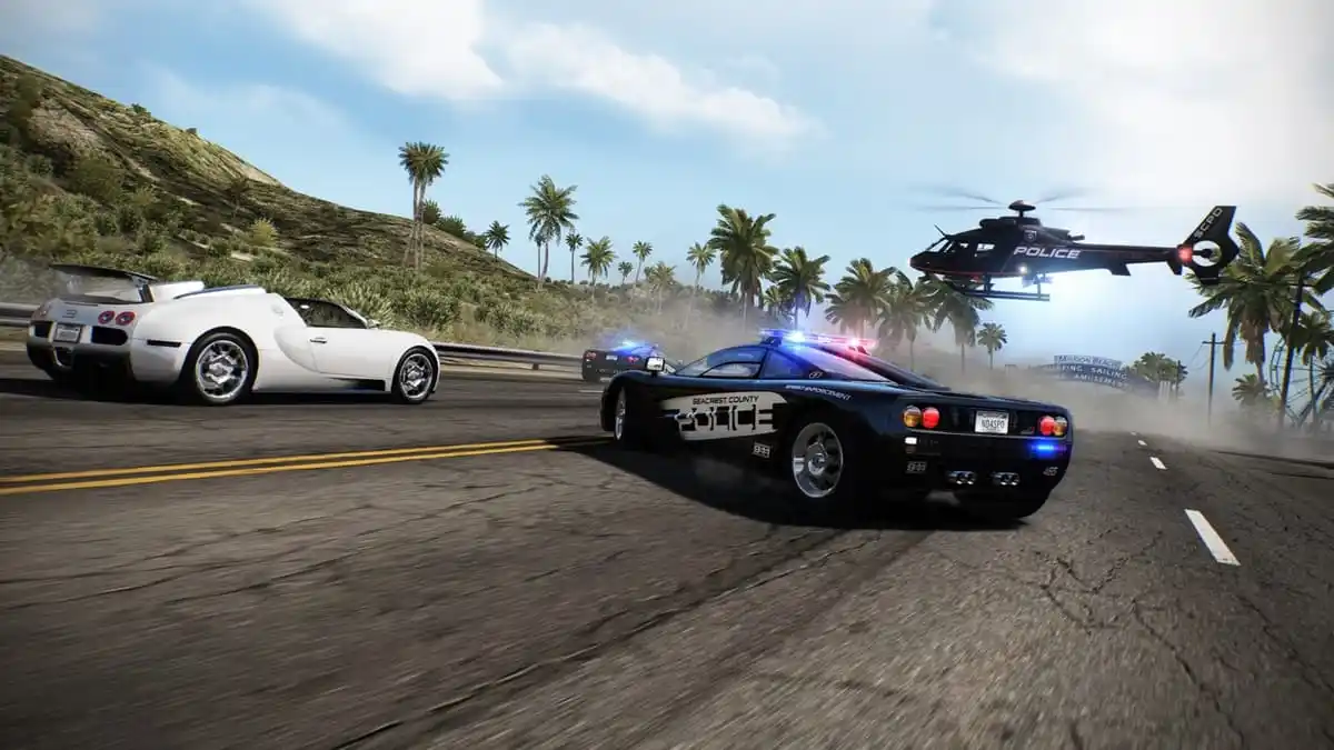 White sports car surrounded on the road by two police cars and a helicopter with trees in the background