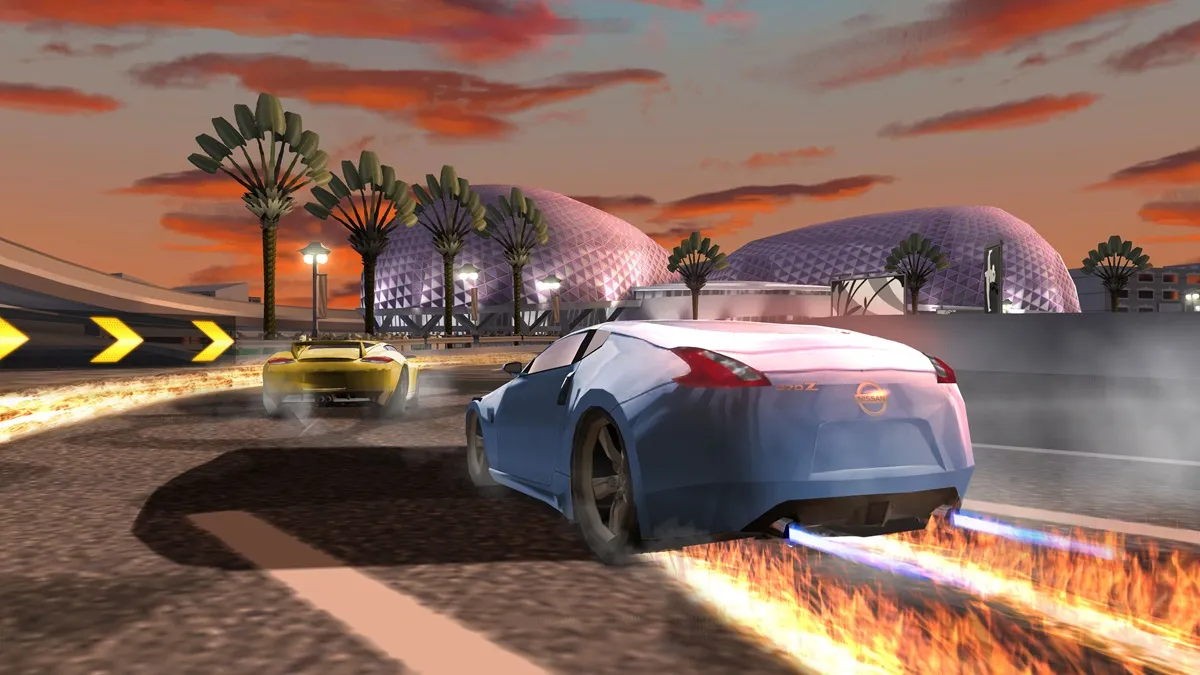 White sports car setting the street on fire racing against a yellow sports car with trees in the background