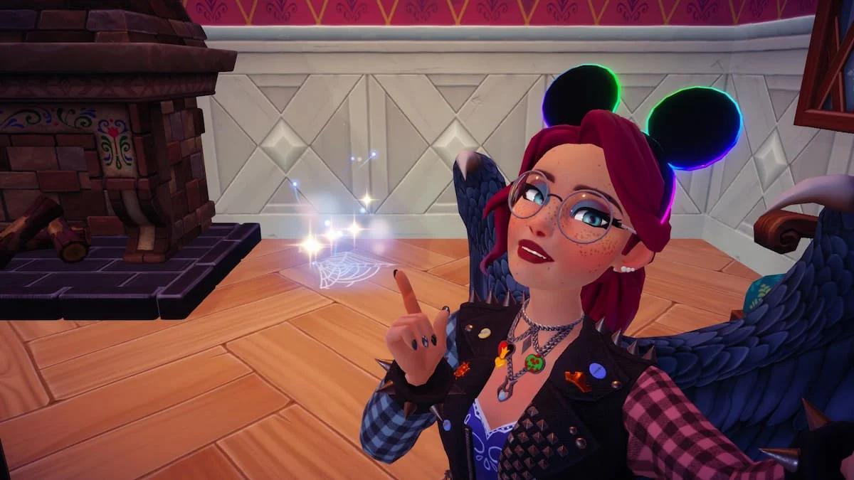 A player pointing at a sparkling Spiderweb on the ground in Disney Dreamlight Valley.