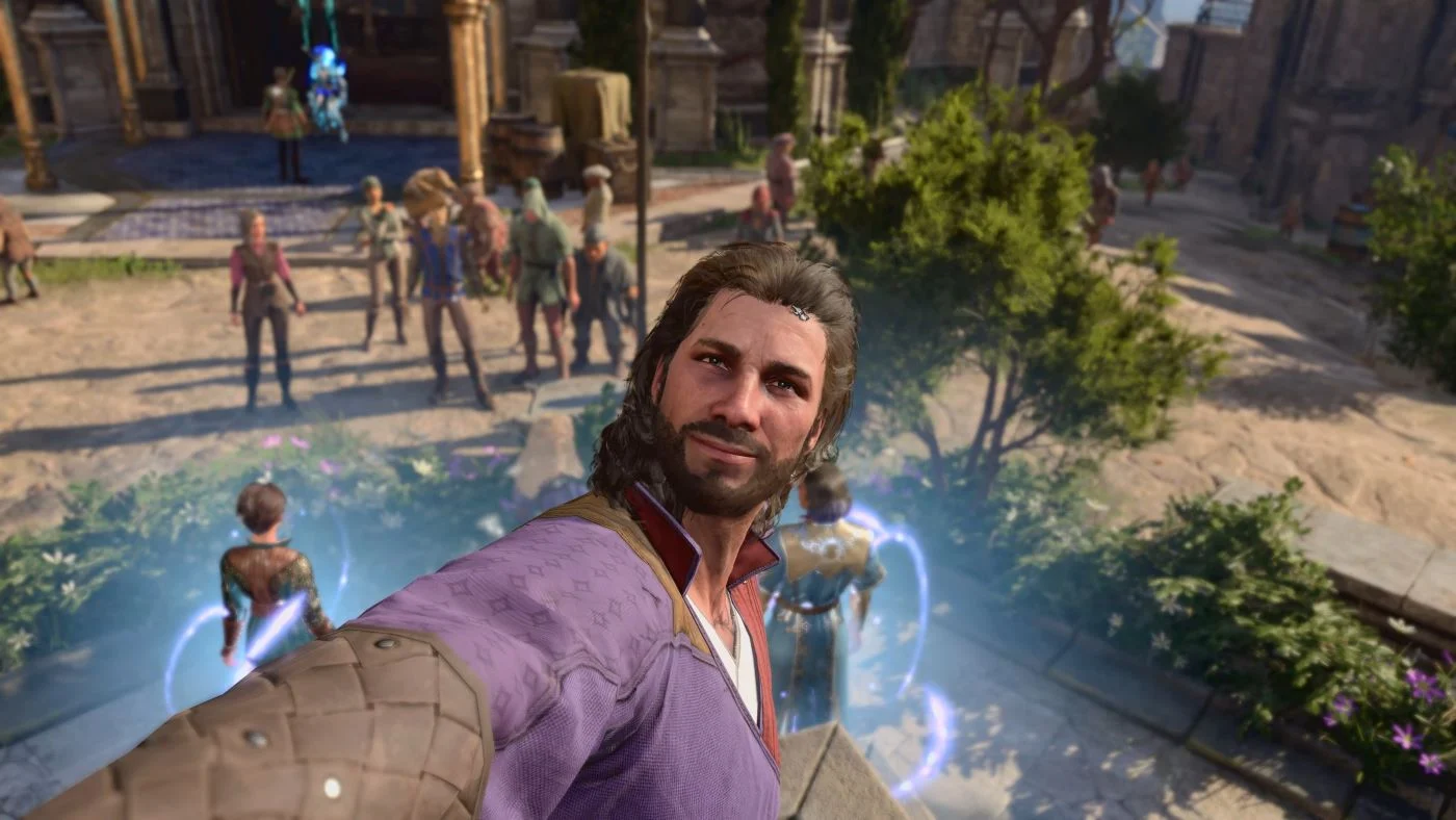 Gale, a brown-haired male human wizard from Baldur's Gate 3, stands at the center of a city square and smiles at the camera with his arm outstretched as if taking a selfie.