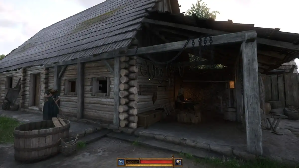 A wooden cottage with a blacksmith working at the forge in Kingdom Come Deliverance 2