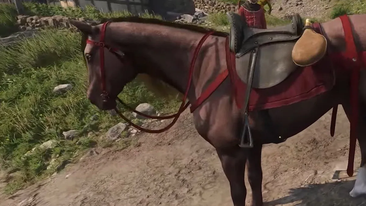 Herring brown horse with red saddle in Kingdom Come: Deliverance 2.