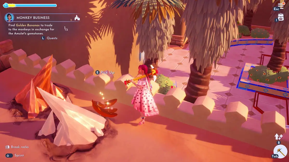 A player with long pink braids and a pink strawberry dress standing next to some golden bananas on the ground in Disney Dreamlight Valley.